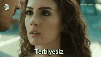 a close up of a woman 's face with the words terbiyesiz written on it