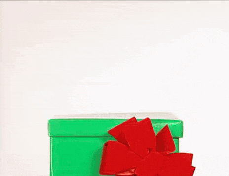 a toy reindeer is coming out of a green box with a red bow .