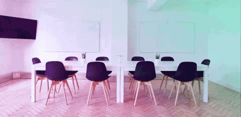 a row of tables and chairs in a room