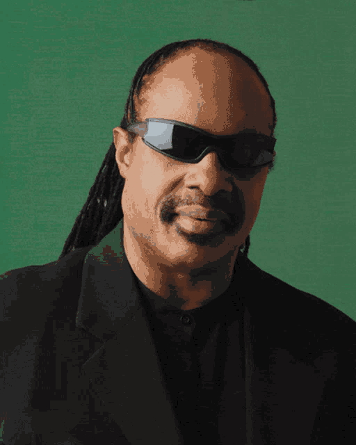 a close up of a man wearing sunglasses and a suit