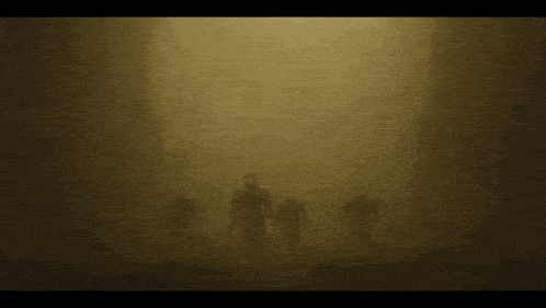 a group of figures are standing in front of a light