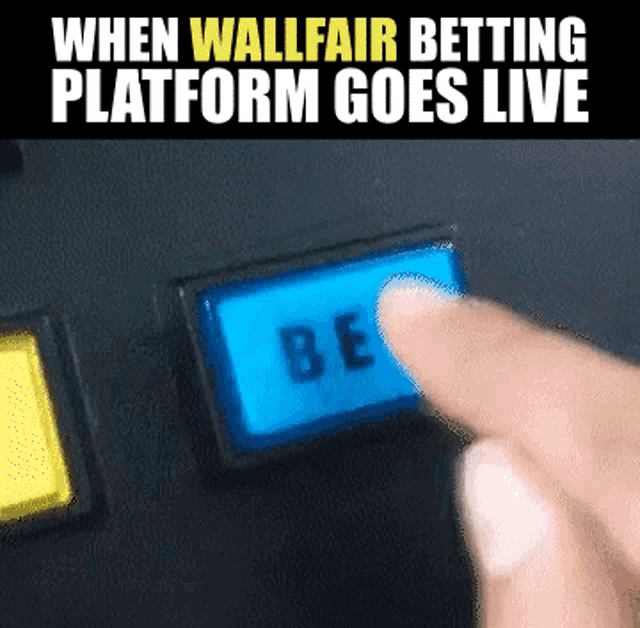 a person pressing a blue button that says be