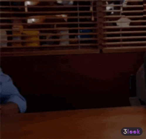 a man sitting at a table with a 3look sticker on the bottom right