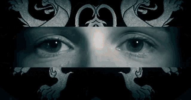 a black and white photo of a woman 's eyes with a dragon on the bottom right