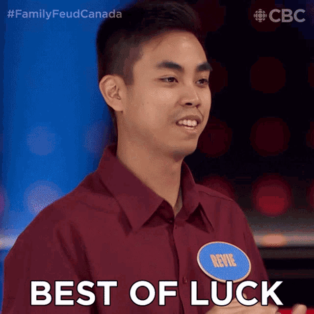 a man in a maroon shirt with a name tag that says best of luck
