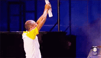 a man in a yellow and white shirt is holding a torch in his hand