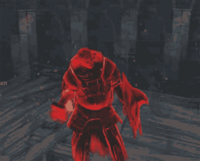 a man in a red armor is standing in a dark room
