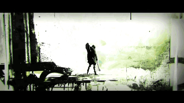 a silhouette of a man holding a gun in front of a wall with the letter a on it