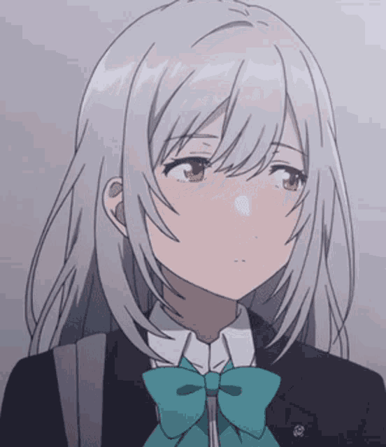a girl with long gray hair and a green bow tie is wearing a suit and tie .