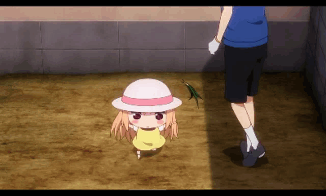 a little girl wearing a white hat is standing next to a man in a blue shirt