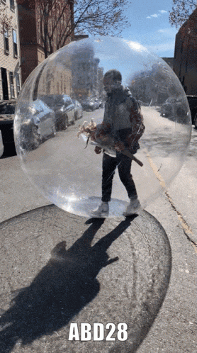 a man is standing in a clear bubble with abd28 written on the bottom