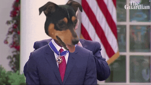 a man in a suit and tie with a dog 's head and a medal around his neck with the guardian written on the bottom