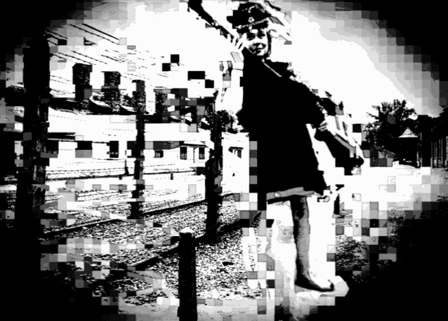 a black and white photo of a person standing in front of a train track