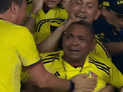 a man in a yellow shirt is surrounded by other men