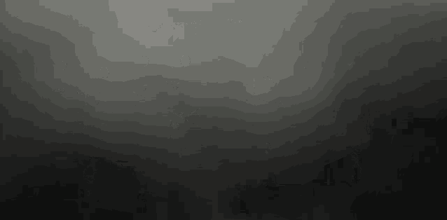 a black background with a gray gradient and a gray smoke coming out of it .