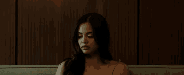 a woman is sitting on a couch with her eyes closed