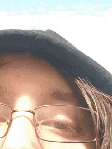 a close up of a person 's face with glasses