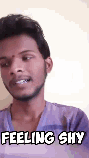 a man in a purple shirt is making a funny face and says feeling shy