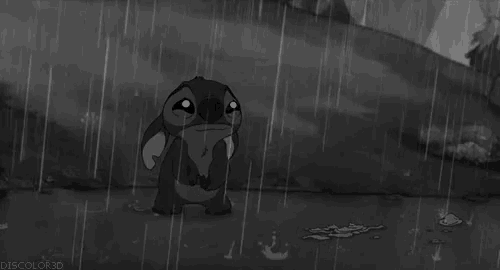 stitch from disney 's lilo and stitch is standing in the rain .