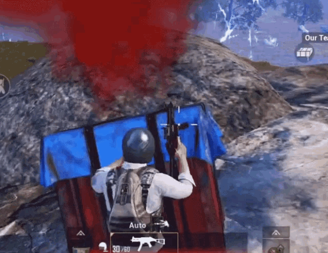 a man is holding a gun in front of a blue umbrella that says " auto " on it