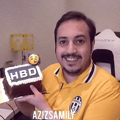 a man in a yellow shirt is holding a cake with the word hbd on it