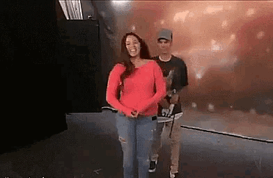a man and a woman are dancing on a stage .