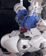 a close up of a robot with a blue and white body