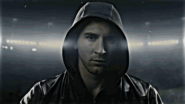 a man wearing a black jacket with a hood