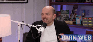 a man sitting in front of a microphone with the words dark web on the bottom right