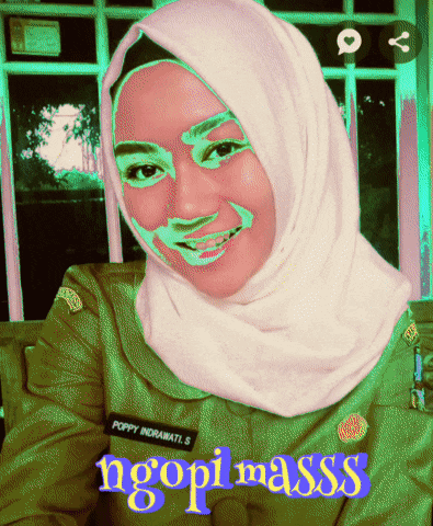 a woman wearing a hijab has the name poppy indrawati s on her jacket
