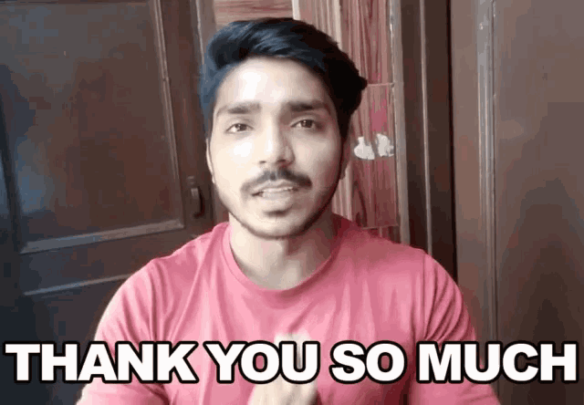 a man in a red shirt is giving a thank you so much sign