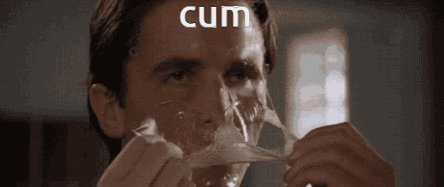 a man with a condom on his face and the word cum written above him