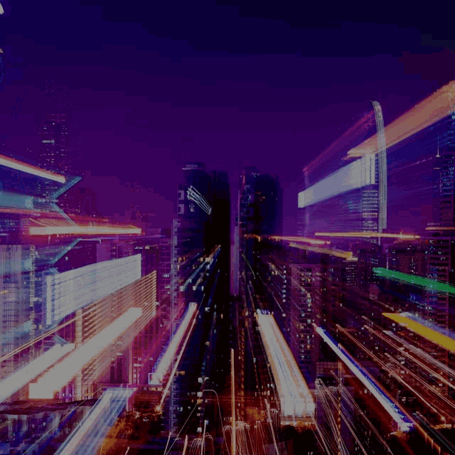 a blurry photo of a city at night with a purple sky in the background
