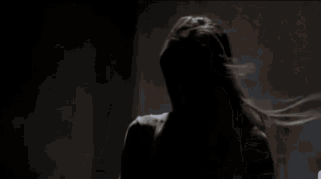 a man and a woman are fighting in a warehouse