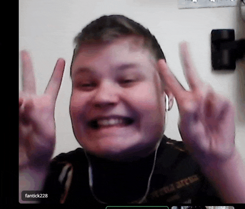 a young man giving a peace sign with the name fantick228 on the bottom