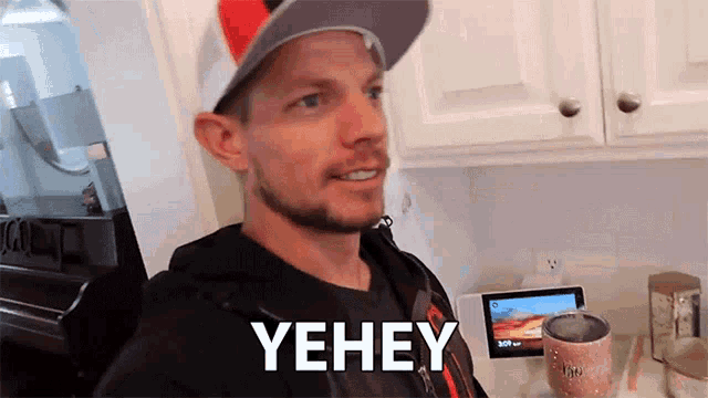 a man wearing a baseball cap says yehey