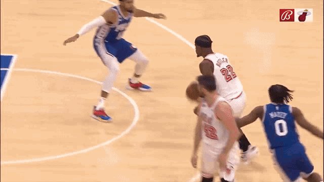 a basketball player with the number 22 on his jersey is dribbling the ball