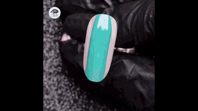 a close up of a person applying nail polish to a nail