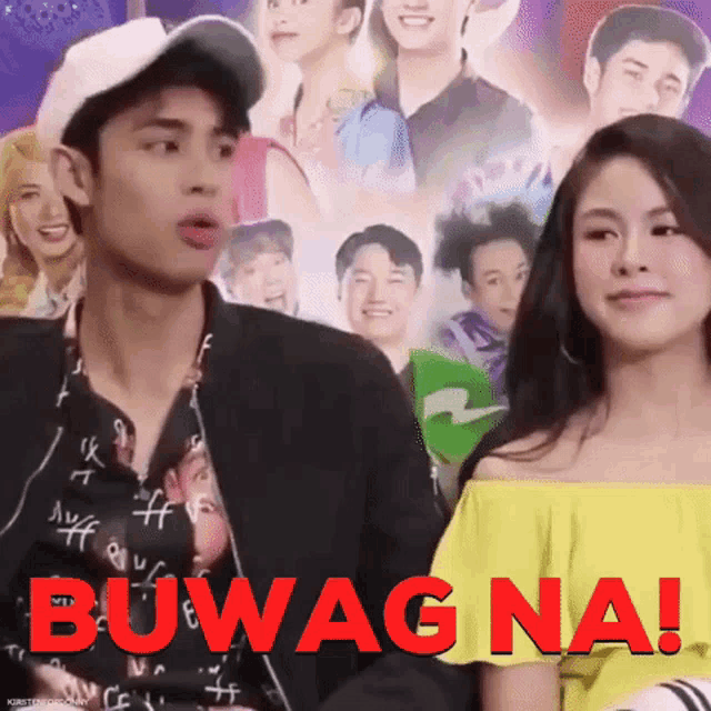a man and a woman are sitting in front of a poster that says buwag na .