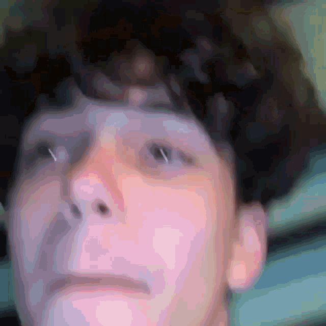 a close up of a person 's face with a piercing in the nose