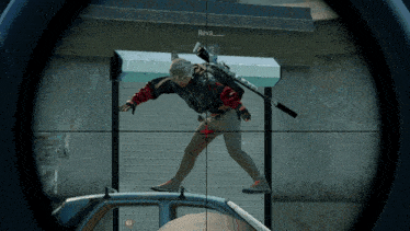 a sniper scope shows a man standing on a car with the name reva on the bottom right