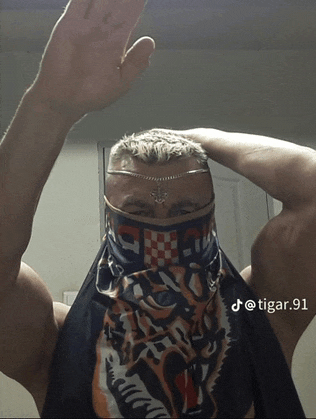 a man wearing a bandana with a tiger on it and the number 91 on the bottom