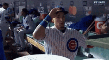a cubs baseball player is sitting in the dugout