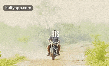 a man is riding a motorcycle down a dirt road with a woman on his back .