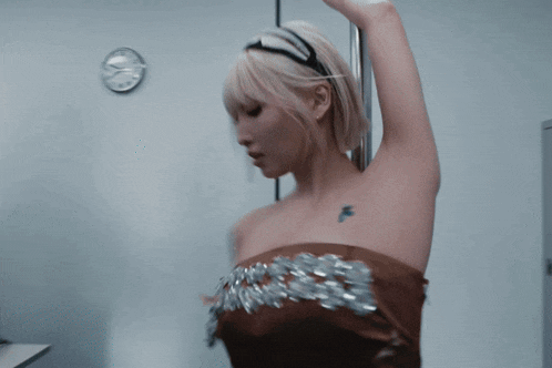 a blurry picture of a woman 's back with her hair blowing in the air