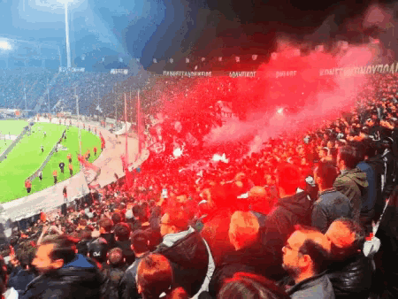 a crowd of people in a stadium watching a soccer game with a sign that says ' konett ' on it