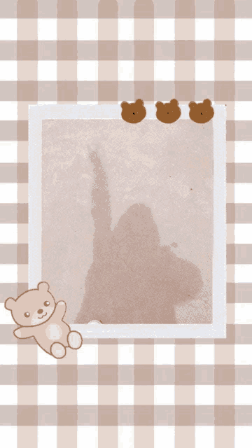a picture frame with three teddy bears and a shadow of a person