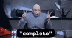 a bald man is giving a peace sign in front of a sign that says " complete " .