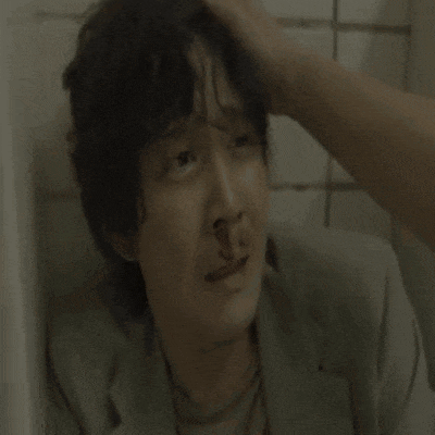 a close up of a man 's face with a bloody nose