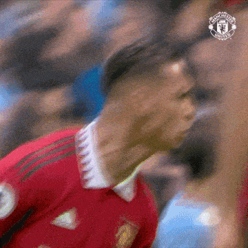 a close up of a soccer player in a red shirt .